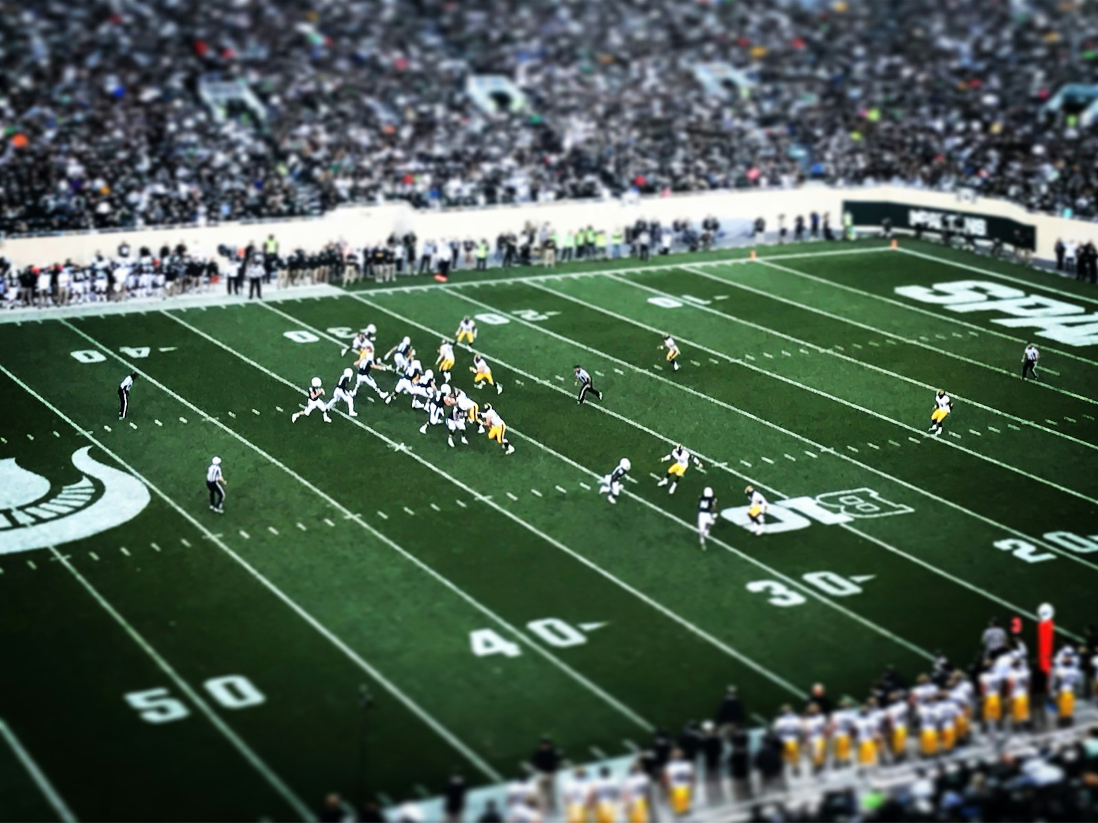 Aerial view of a packed football field and crowded stands