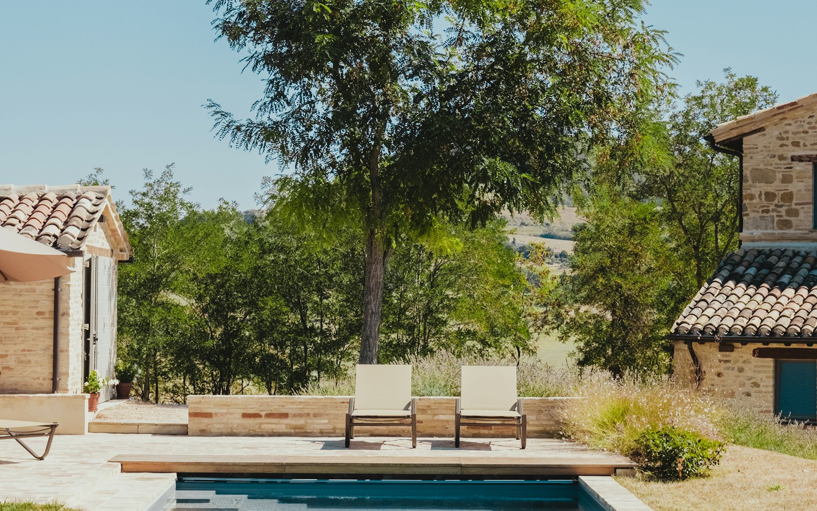 Private backyard pool at a vacation home on a sunny afternoon